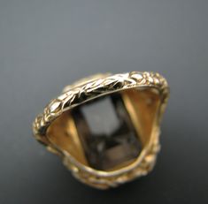 "PRE-OWNED For Sale: (1) Beautiful Vintage Emerald Cut Smokey Quartz Mounted in a 14k Yellow Gold Ring PLEASE READ ENTIRE DESCRIPTION BEFORE PURCHASING Please see pictures for more details! This is a lovely emerald cut smokey quartz ring in 14k yellow gold filigree mounting with bows on each side. The embossed filigree design does cover the whole ring band. This ring is stamped 14k. A very nice ring. Specifics: 14k Yellow Gold Smokey Quartz approx. 16 mm x 11.3 mm Size: 7 Weight - 5.8 grams If y Collectible 14k Gold Jewelry With Bezel Setting, Yellow Gold Jewelry With Bezel Setting For Formal Occasions, Formal Yellow Gold Jewelry With Bezel Setting, Luxury Collectible Diamond-cut Jewelry, Antique Emerald Cut Gold Jewelry, Antique Gold Emerald Cut Jewelry, Antique Emerald Cut Yellow Gold Jewelry, Antique Bezel Setting Formal Jewelry, Antique Formal Jewelry With Bezel Setting