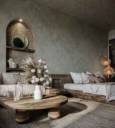 a living room with two beds and a coffee table in front of the couches