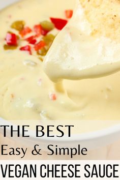 the best easy and simple vegan cheese sauce is in a white bowl with a spoon