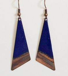 "I make these earrings by torch firing cobalt blue enamel onto a 1 7/8\" long copper triangle shape, and the technique of flame painting the copper at the bottom of the triangle. They are shown on a hypoallergenic copper earwire. Total length of earring including wire is about 2 1/4\" long. They are lightweight and fun to wear. They can be dressed up or worn casually. Grab a triangle necklace to make a set! They are definitely one of a kind!" Unique Blue Copper Earrings, Blue Artisan Copper Earrings, Artisan Blue Copper Earrings, Blue Teardrop Copper Earrings, Blue Copper Teardrop Earrings, Bohemian Blue Electroformed Earrings, Artsy Blue Metal Jewelry, Artsy Blue Teardrop Earrings, Bohemian Blue Enamel Earrings