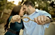 a man and woman are holding on to a rope