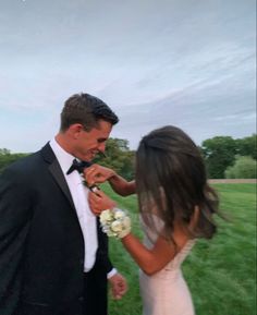 a man in a tuxedo feeding a bride