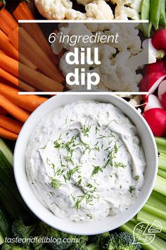 a white bowl filled with dip surrounded by vegetables