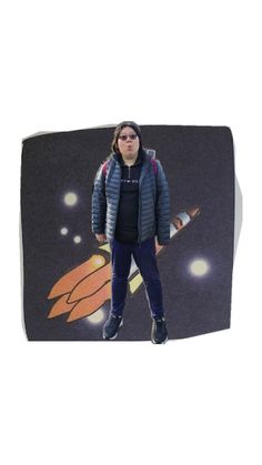 a woman standing in front of a photo of a rocket ship on a black background