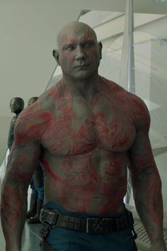 a man with red paint on his body and chest