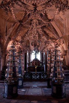 the interior of an old church with elaborate carvings and chandeliers hanging from the ceiling