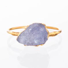 This rough tanzanite features violet hues accented by 24k yellow gold.   A great gift for December birthdays, as Tanzanite is the birthstone for December. This raw gemstone ring also exhibits complex and interesting electroforming texture around the edges of the gemstone.  This ring stacks well with other gold rings.✨14k Gold Filled Shank24k Gold Dipped for deeper color. Genuine Raw Tanzanite5-10mm wide. ✨Please read our FAQ for more information on our unique materials and process. You will rece Women Gold Ring, Ring For Women Gold, Raw Tanzanite, Rough Gemstone Ring, Ring Stacks, Kyanite Ring, Raw Crystal Ring, Raw Gemstone Ring, Raw Stone Ring