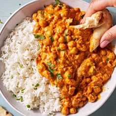 a bowl filled with rice and beans next to a pita bread on top of it