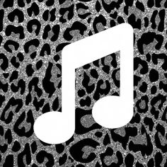 a white music note sitting on top of a leopard print background