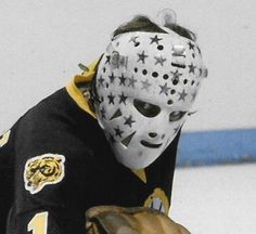 a hockey player wearing a mask and holding a glove