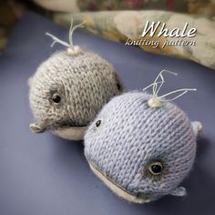 two knitted stuffed animals sitting next to each other on a blue surface with the caption whale knitting pattern