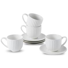 four white cups and saucers sitting on top of each other