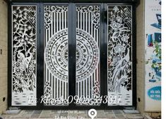 an iron gate with intricate designs on the front and side doors, which are decorated with flowers