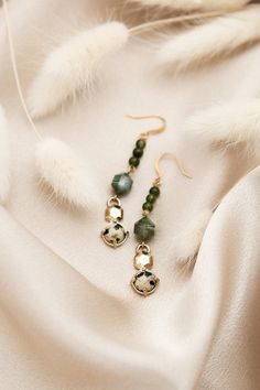 Our Logan earrings showcase the exquisite claudette design in a stunning drop style. Measuring approximately 2 inches in length, these beauties add a touch of sophistication and elevate any outfit to a new level of luxury. Materials & Details Available in 3 variations: moonstone and freshwater pearl; sodalite, labradorite and moonstone; or green serpentine, moss agate, and dalmatian jasper* approx 2 inch at longest measurement Gold plated brass ear wires | Free of nickel, lead, and cadmium *Stone colors and patterns will vary slightly, but will be just as beautiful and similar to the colors shown. Elegant Jade Teardrop Earrings, Elegant Natural Stone Dangle Teardrop Earrings, Elegant Jade Dangle Earrings, Elegant Dangle Teardrop Earrings With Natural Stones, Elegant Teardrop Jade Earrings, Metal Drop Earrings With Natural Stones, Elegant Long Drop Gemstone Bead Jewelry, Elegant Gemstone Beads Earrings For Gift, Elegant Green Gemstone Beaded Earrings