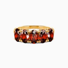 a gold ring with red stones on it