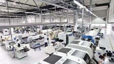 an assembly line in a factory with workers working on machines