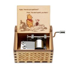 a wooden music box with winnie the pooh on it