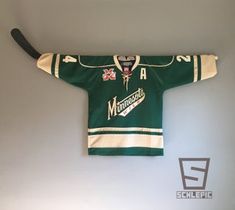 an old hockey jersey hanging on the wall