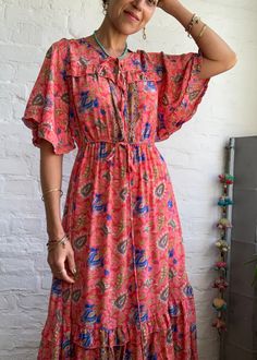 "This is cute easy to wear boho style long dress with wide flared sleeves and cute v neckline with tassel tie it is made free size with high waist and strap tie to fit most of sizes MEAESURE shoulder 17\" bust 40\" Elastic high waist up to 36\" length 55\" MATERIAL *poliester *no lining More boho style ideas at https://www.etsy.com/shop/AltheaStores? CARE INSTRUCTIONS * Wash in warm water * Hand wash recommended * Hang to dry IMPORTANT NOTE * Please note that colour shown on your monitor may var Bohemian V-neck Maxi Dress For Brunch, Bohemian V-neck Wrap Dress For Brunch, Feminine Boho Maxi Dress For Summer, Elegant Boho Print Maxi Dress For Festival, Spring Festival V-neck Maxi Dress, Pink Bohemian V-neck Maxi Dress, Feminine Boho Maxi Dress For Vacation, Chic Flowy Boho Dress For Festivals, Bohemian V-neck Rayon Maxi Dress