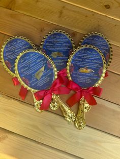 three blue plaques with red ribbons on top of wooden planks and wood flooring