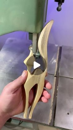 a person is using a machine to cut wood with a pair of plywood shears