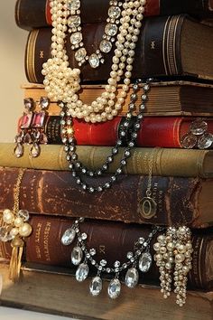 a stack of books with pearls on them