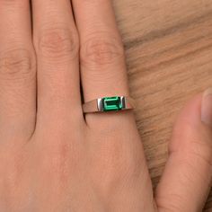 It is a lab emerald ring. The main stone is 5mm*7mm emerald cut, weight about 0.87 carats. The basic metal is sterling silver and plated with rhodium. To change the metal to a solid gold (white/rose) or platinum is also available, please ask for a quotation if you want. You can also go to my shop Home for more elegant rings: https://www.etsy.com/shop/godjewelry?ref=hdr_shop_menu More emerald rings: https://www.etsy.com/shop/godjewelry?section_id=20709240 Customization is always welcome and pleas Minimalist Emerald Cut May Birthstone Ring, Minimalist May Birthstone Ring With Emerald Cut, Minimalist Emerald Cut Emerald Ring For May, Minimalist Emerald Cut Emerald Ring, Modern Emerald May Birthstone Ring, Minimalist Emerald Cut Sterling Silver Birthstone Ring, Minimalist Emerald Cut Birthstone Ring In Sterling Silver, Modern Emerald Cut Solitaire Birthstone Ring, Modern Solitaire Emerald Cut Birthstone Ring