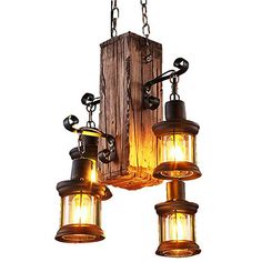 an old fashioned light fixture with three lights hanging from it's sides and chains on the