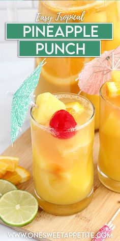 two glasses filled with pineapple punch on top of a cutting board