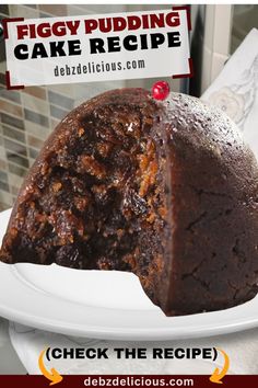 a piece of cake sitting on top of a white plate next to a sign that reads, figgy pudding cake recipe check the recipe