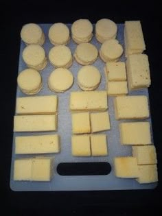 several pieces of cheese are arranged on a cutting board