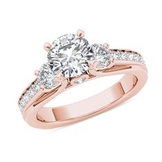 a rose gold engagement ring with three stones