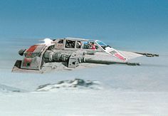 a fighter jet flying through the sky with mountains in the background