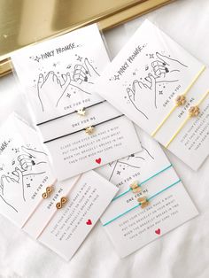 five cards with different designs on them sitting next to each other in front of a gold frame