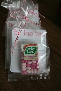 two bags with pink and white candies wrapped in plastic