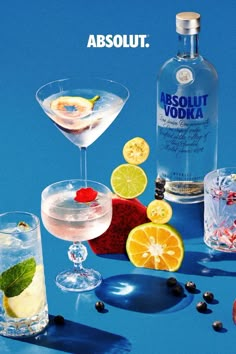 an advertisement for absolut vodka with lemons, raspberries and other drinks