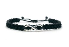 hand-made black color string bracelet with a silver tone infinity charm, adjustable for wrist sizes from 6 to 9 in.  the infinity charm is about 1 inch long To some wearing the infinity symbol it can symbolize its more modern interpretation of eternity and everlasting love. However, to others their connection to the infinity draws from its ancient understanding as the symbol of perfection, duality and empowerment.  Each bracelet is carefully handcrafted and given proper time to ensure quality. Trendy Adjustable Silver Friendship Bracelets, Silver Braided Bracelet With Adjustable Length For Friendship, Black Sterling Silver Bracelets For Friendship, Silver Braided Jewelry For Friendship, Black Sterling Silver Jewelry With Adjustable Length, Adjustable Infinity Friendship Bracelets, Casual Silver Hypoallergenic Friendship Bracelets, Elegant Black Braided Bracelets For Friendship, Elegant Black Braided Bracelets