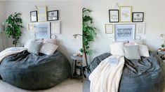 two bean bag chairs in a bedroom with pictures on the wall and plants growing out of them