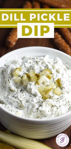 dill pickle dip in a white bowl surrounded by pretzels