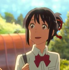 an anime character with black hair wearing a white shirt and red bow tie standing in front of trees