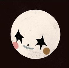 a white plate with black stars and a clown face on it's side, in front of a dark background