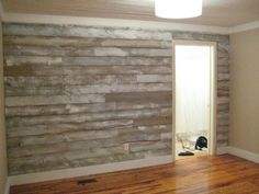 a room with a wood paneled wall next to a door