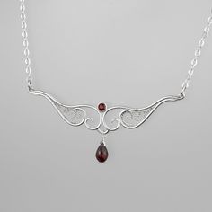 Delicate silver filigree and deep red garnet make this necklace the special finishing touch to your outfit - whether that's a pretty blouse or a little black dress. Fancy enough for special occasions but sweet and delicate enough for a regular Tuesday at work, this piece is handcrafted with care to last for years of enjoyment. Finished with a handmade S-hook clasp and a peridot accent dangle. Materials: Sterling silver, fine silver, genuine garnet Size: pendant 2.5" across Necklace length: 16" a Black Dress Fancy, Dress Fancy, A Little Black Dress, S Hook, Pretty Blouses, Hook Clasp, Silver Filigree, Red Garnet, Necklace Length