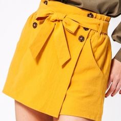 Our Lily Skort Is A Must For The Season!! The Color Is One Of Pantones Top 10, The Style Is So Classy And Have Be Styled Casually Or Dressy! These Paper Bag Waist Skort Feature Button Details And My Favorite Pockets! True To Size Model Is 5' 9" Tall, 34b Chest, 26" Waist And 35" Hips And Wearing Size Small Keywords: High Waisted Cargo Shorts Fall Winter Spring Summer Resort Vacay Styles Date Night Cruise Bohemian Bikini Vintage Embroidery Ready To Wear Flirty Hippie Crochet Chic Trendy Maxi Cove Mustard Skirt, Layering Cardigan, Professional Pants, Hippie Crochet, Bachelorette Dress, Trendy Blouses, Striped Blazer, Lace Bodysuit, Black Cardigan