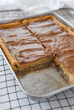 a close up of a cake in a pan with chocolate frosting on the top