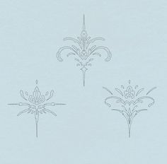 three fleur de lys designs on a light blue background, each with an intricate design