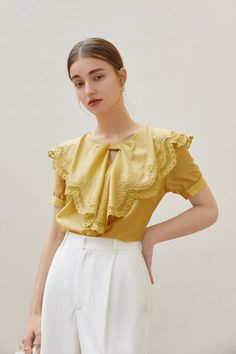 Fabric: 83.7% Lyocell 16.3% Polyester Color: Yellow Care: Hand wash or gentle machine wash A oversized lace bow collar blouse with short puff sleeves. Regular silhouette and slips on. While it has all the usual tropes of a classic blouse , and it is topped with a statement lace collar. Model is 173cm/5'8" tall and wearing a size M. Collar Model, Ruffle Collar Blouse, Classic Blouse, Classic Blouses, Bow Collar, Lace Bows, Ruffle Collar, Fashion Gallery, Collar Top