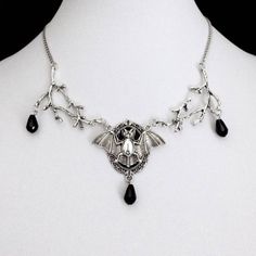 A striking piece of jewelry that embodies the essence of dark magic and Gothic elegance. This intricately designed necklace features a large and detailed bat pendant hanging from a sturdy and stylish chain. The bat pendant is infused with a mysterious energy that radiates from its intricate design, making it a perfect accessory for any wizard or witch seeking to channel their inner power. With its bold and captivating design, this necklace is the perfect statement piece to complete your gothic look. The energy-infused bat pendant adds an air of mystery and intrigue, while the sturdy chain ensures it stays securely around your neck. Whether you're attending a gothic event, seeking to enhance your magical powers, or simply expressing your individuality, the Gothic Mysterious Energy Wizard Ba Gothic Pendant Necklace For Halloween, Gothic Metal Necklace, Halloween Gothic Pendant Necklace, Gothic Halloween Chain Necklace, Black Fantasy Pendant Necklace, Fantasy Black Pendant Necklace, Black Metal Fantasy Necklace, Pagan Magic, Bat Pendant