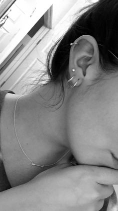 a woman with piercings on her ear laying down