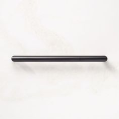 a black handle on a white wall